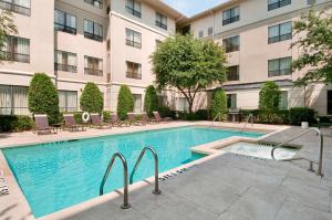 a swimming pool in front of a building at Hyatt House Dallas Uptown in Dallas