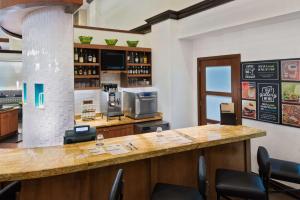 a bar in a restaurant with a counter and chairs at Hyatt Place Ft. Lauderdale/Plantation in Plantation