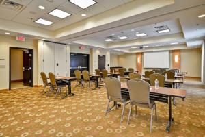 a conference room with tables and chairs and a whiteboard at Hyatt Place Chicago/Naperville/Warrenville in Warrenville