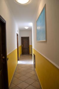 a hallway with yellow and white walls and a door at Luna D'Agerola in Agerola