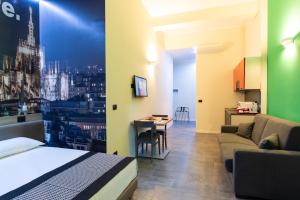 a bedroom with a bed and a couch and a table at Aparthotel Porta Nuova in Milan