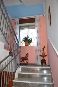 a hallway with stairs with a horse standing on it at Luna D'Agerola in Agerola