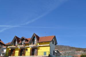 a yellow house with a red roof at Luna D'Agerola in Agerola