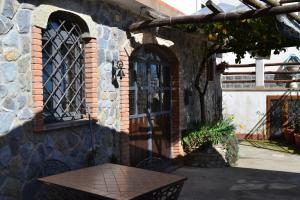 a brick building with a table in front of a door at Luna D'Agerola in Agerola