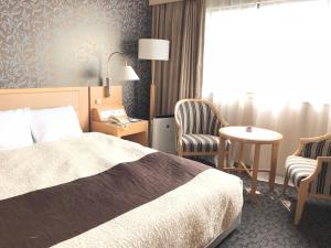Una cama o camas en una habitación de Numazu River Side Hotel