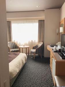 Una cama o camas en una habitación de Numazu River Side Hotel