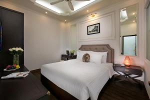 Voodi või voodid majutusasutuse Golden Rooster Hotel toas