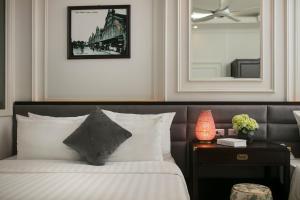Voodi või voodid majutusasutuse Golden Rooster Hotel toas