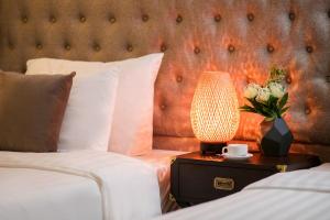 Voodi või voodid majutusasutuse Golden Rooster Hotel toas