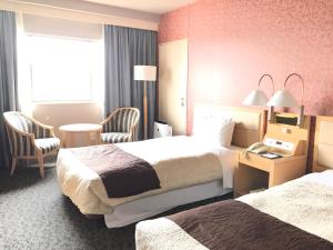 Una cama o camas en una habitación de Numazu River Side Hotel