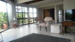 a living room with a couch and a television at Apartment Atrium in Grand Baie