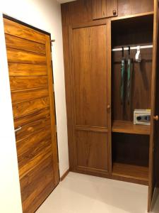 a closet with a wooden door in a room at Crystal Lamai Hotel in Lamai