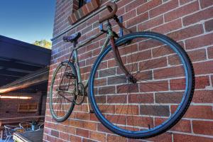 a bike is hanging on a brick wall at Pleasant Way River Lodge in Nowra