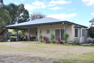 a small house with a pitched roof at Back Valley Farmstay Bed and Breakfast in Victor Harbor