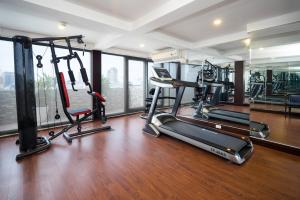 a gym with treadmills and exercise equipment in a building at Nhat Ha 2 Hotel in Ho Chi Minh City