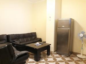 a living room with a couch and a refrigerator at Melania's house in Batumi
