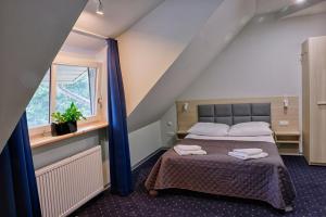 Postel nebo postele na pokoji v ubytování Hotel Podjadek