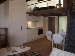 a small apartment with a loft bed and a table and chairs at Appart face au mail in Limoges