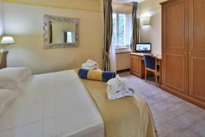 Postel nebo postele na pokoji v ubytování Hotel & Terme Bagni di Lucca