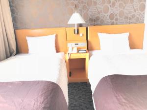 Una cama o camas en una habitación de Numazu River Side Hotel