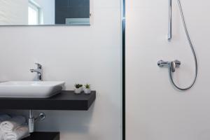 a bathroom with a sink and a shower at Pansion Leggero in Krk