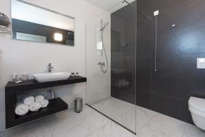 a bathroom with a shower and a toilet and a sink at Pansion Leggero in Krk