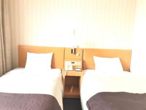Una cama o camas en una habitación de Numazu River Side Hotel