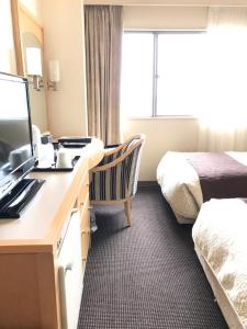 Una cama o camas en una habitación de Numazu River Side Hotel