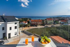 a bowl of fruit on a table on a balcony at Pansion Leggero in Krk