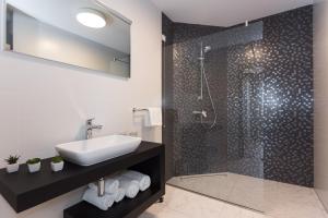 a bathroom with a sink and a shower at Pansion Leggero in Krk