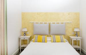 a bedroom with a white bed with two night stands at Elisir B&B in Anacapri