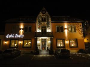 a building with a sign in front of it at night at Hotel Krone in Rielasingen-Worblingen