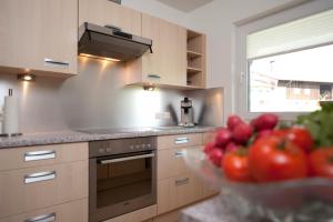 a kitchen with a bowl of tomatoes on the counter at Ferienwohnungen Alpentraum - Alpentraum in Obermaiselstein