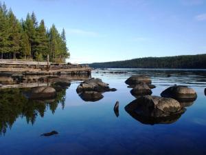 a body of water with rocks and a dock at Arctic Island - Remote island, reachable only by boat or snowmobile in Kurravaara