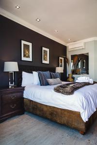 a large bedroom with a large bed and two lamps at 512 The Granger in Cape Town