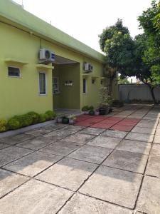 a yellow house with a red tile driveway at de' GREEN Cibubur in Cibubur