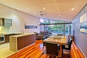 a kitchen and living room with a table and chairs at Central Avenue Apartments in Margaret River Town