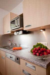 a kitchen with a bowl of vegetables on a counter at Ferienwohnungen Alpentraum - Alpentraum in Obermaiselstein