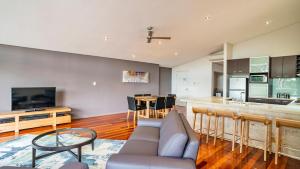 a living room with a couch and a kitchen at Central Avenue Apartments in Margaret River Town