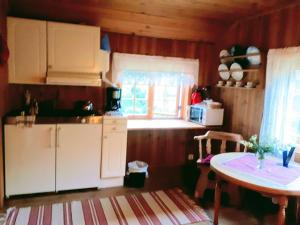 a small kitchen with a table and a window at Teigen Gard in Lom