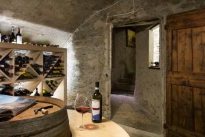 a bottle of wine sitting on a table with a glass at Hotel Tremoggia in Chiesa in Valmalenco