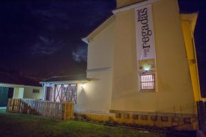a building with a sign on the side of it at night at Hospedagem Casa das Regadas in Vale de Cambra