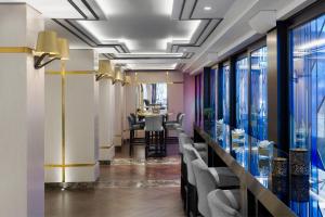 a lobby with a bar with chairs and tables at InterContinental Sofia by IHG in Sofia