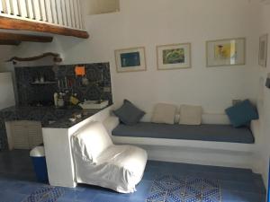 a room with a bed and a chair in it at Villa in Panarea - Nespolo in Panarea