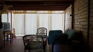 a living room with a couch and chairs and a window at Nuweiba Lodge in Nuweiba