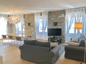 a living room with two couches and a dining room at Ritter'S Rooms & Apartments in Trieste