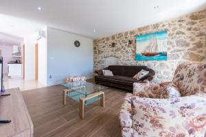 a living room with a couch and a glass table at Villa Dundo Pero in Babino Polje