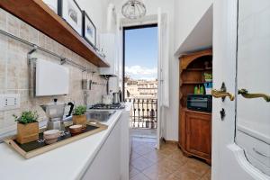 a kitchen with a counter top and a window at Spagna Penthouse in Rome