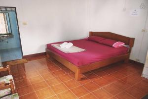 Postel nebo postele na pokoji v ubytování Thai Muang Resort