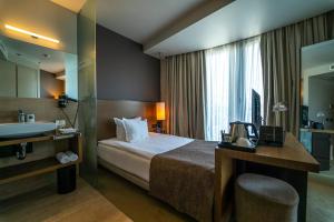 Postel nebo postele na pokoji v ubytování mOdus Hotel